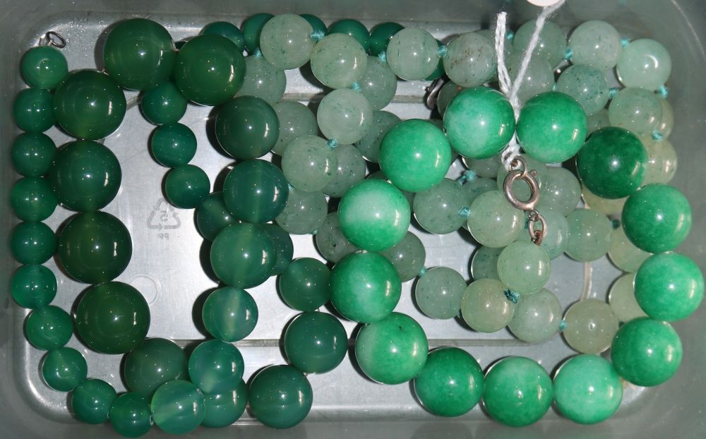 Two simulated jade necklaces and a stained jade? bracelet.